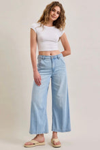 Load image into Gallery viewer, Woman wearing a white crop top and light blue jeans on a plain background