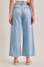 Load image into Gallery viewer, Light blue wide-leg jeans worn by a person on a beige background