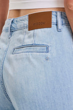 Load image into Gallery viewer, Light blue denim jeans with a brown leather patch displaying the word 'HIDDEN'.