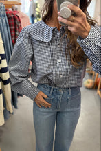 Load image into Gallery viewer, Person wearing a checkered shirt and jeans in a clothing store.