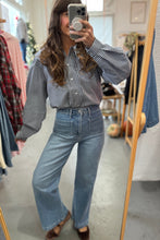 Load image into Gallery viewer, Person taking a mirror selfie wearing a checkered shirt and jeans in a clothing store.