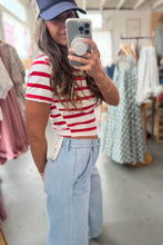 Load image into Gallery viewer, Person taking a mirror selfie wearing a red and white striped shirt and light blue jeans in a clothing store.