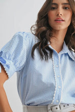 Load image into Gallery viewer, Woman wearing a light blue blouse with puffed sleeves against a plain background