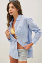 Load image into Gallery viewer, Woman wearing a light blue shirt over a bikini with gray shorts on a plain background