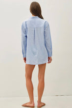 Load image into Gallery viewer, Woman wearing a light blue striped shirt over a white dress on a plain background