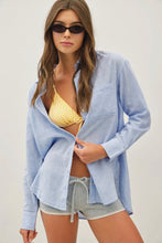 Load image into Gallery viewer, Woman wearing a light blue cover-up over a yellow bikini and gray shorts on a white background