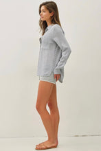 Load image into Gallery viewer, Woman wearing a light gray sweatshirt and shorts on a white background