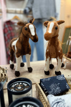 Load image into Gallery viewer, Two plush horse toys on a table with stationery items in the background.