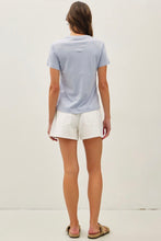 Load image into Gallery viewer, Person wearing a light blue t-shirt and white shorts on a plain background