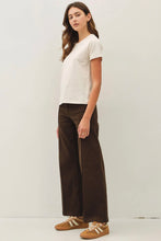 Load image into Gallery viewer, Woman wearing a white top and brown pants on a plain background