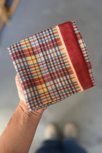 Load image into Gallery viewer, Hand holding a plaid fabric with autumn colors against a neutral background