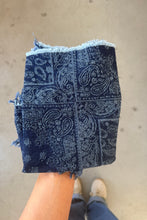 Load image into Gallery viewer, Blue paisley patterned fabric held by a person on a neutral background