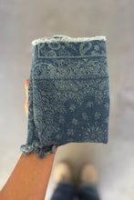 Load image into Gallery viewer, Blue patterned fabric held by a person on a neutral background