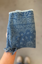 Load image into Gallery viewer, Blue paisley patterned towel held by a person against a neutral background