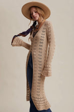 Load image into Gallery viewer, Woman wearing a beige knitted cardigan and hat against a neutral background