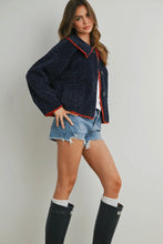 Load image into Gallery viewer, Woman wearing a navy blue jacket with red trim, denim shorts, and black rain boots on a plain background