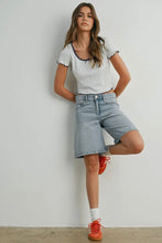 Load image into Gallery viewer, Woman wearing a polka dot top and denim shorts with red shoes against a plain background