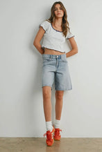 Load image into Gallery viewer, Woman wearing a white patterned crop top, light blue denim shorts, and red sneakers against a plain background