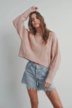Load image into Gallery viewer, Woman wearing a pink knitted sweater and denim shorts against a plain background