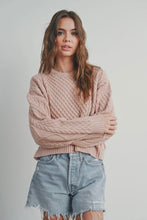 Load image into Gallery viewer, Woman wearing a pink cable knit sweater and denim shorts on a plain background