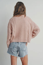 Load image into Gallery viewer, Person wearing a pink cable knit sweater and denim shorts on a plain background