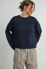 Load image into Gallery viewer, Person wearing a navy sweater and checkered pants on a plain background