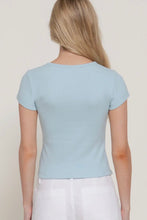 Load image into Gallery viewer, Person wearing a light blue t-shirt and white pants against a plain background