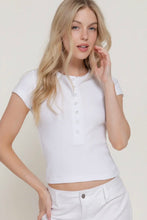 Load image into Gallery viewer, Woman wearing a white cropped top with buttons on a plain background