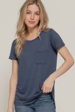 Load image into Gallery viewer, Woman wearing a blue t-shirt with a pocket on a plain background