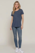 Load image into Gallery viewer, Woman wearing a blue t-shirt and jeans on a plain background