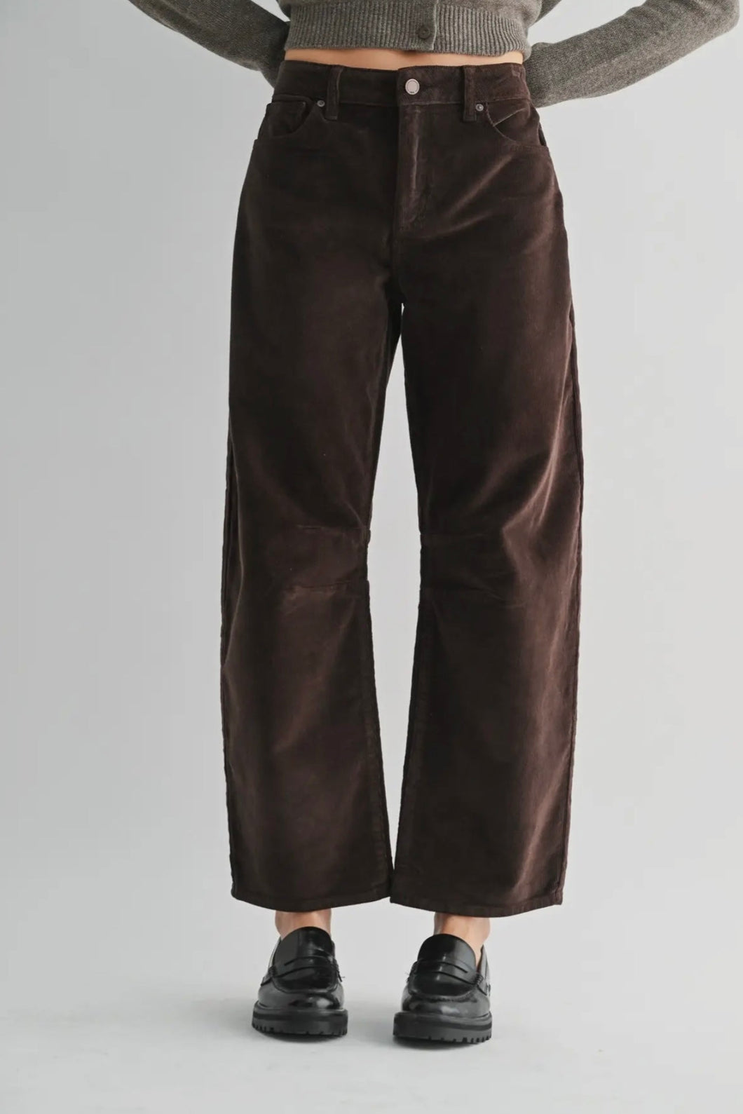 Brown wide-leg pants worn by a person on a gray background