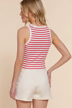Load image into Gallery viewer, Woman wearing a red and white striped tank top and white shorts on a beige background
