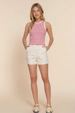 Load image into Gallery viewer, Woman wearing a red and white striped tank top and white shorts on a beige background