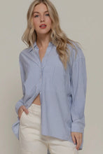 Load image into Gallery viewer, Woman wearing a blue striped shirt and white pants against a plain background