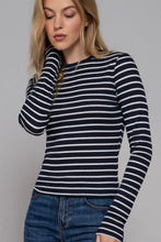 Load image into Gallery viewer, Woman wearing a black and white striped long-sleeve shirt against a gray background