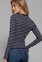 Load image into Gallery viewer, Woman wearing a black and white striped long-sleeve top against a gray background
