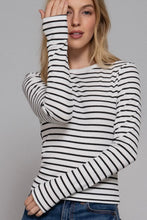 Load image into Gallery viewer, Woman wearing a black and white striped long-sleeve shirt against a gray background