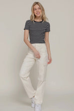 Load image into Gallery viewer, Woman wearing a striped shirt and white pants on a plain background