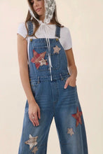 Load image into Gallery viewer, Person wearing denim overalls with star patches on a plain background